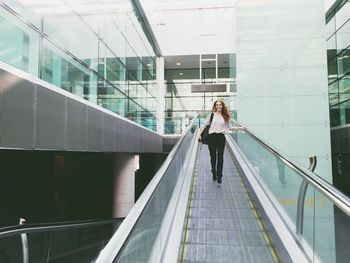 Full length of woman standing in modern building