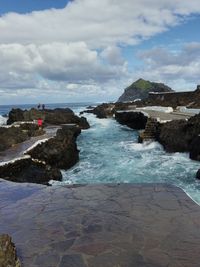 Scenic view of sea against cloudy sky