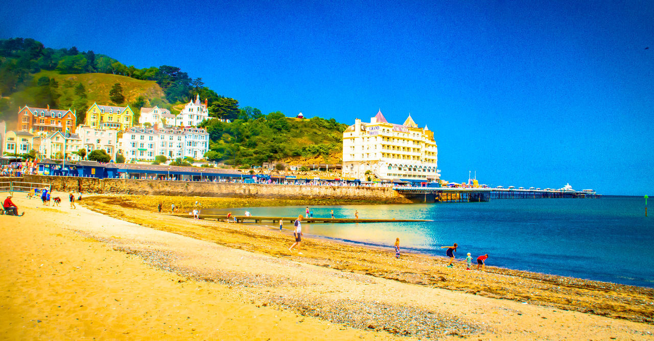 BUILDING BY SEA AGAINST BLUE SKY