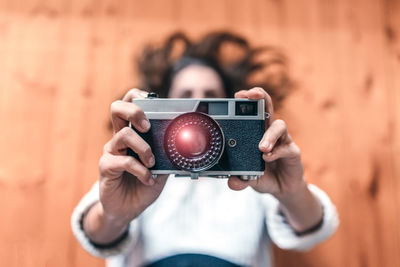 Portrait of woman photographing with camera