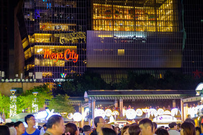 Group of people in front of building at night