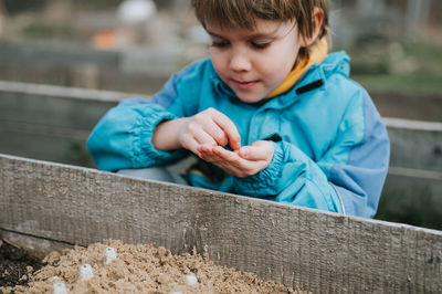 Close-up of boy playing with straw