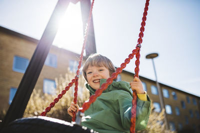 Smiling boy on swing