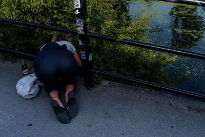 High angle view of people sitting on railroad track