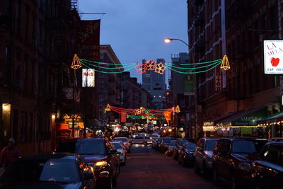 Cars on illuminated street at night