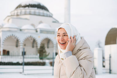 Portrait of smiling young woman in winter