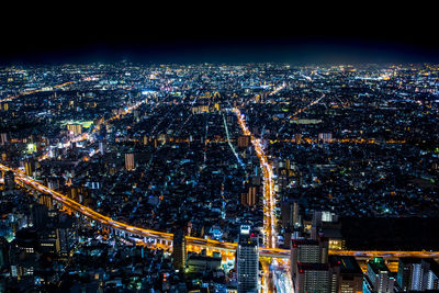 Aerial view of city lit up at night