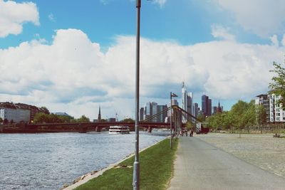 View of cityscape against cloudy sky