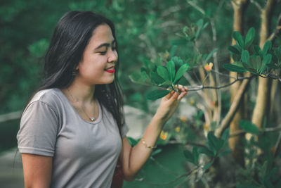 Beautiful young woman with plants