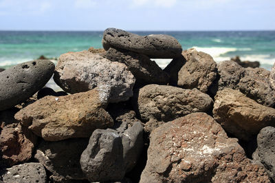 Rocks on beach against sky