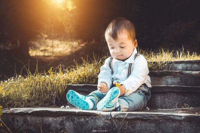 Boy sitting on grass