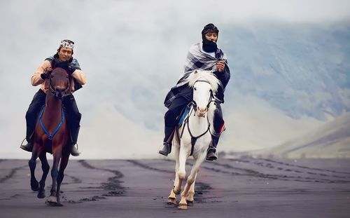 Rear view of man riding horse