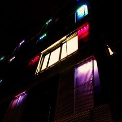 Low angle view of illuminated building at night