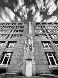 Low angle view of building against cloudy sky