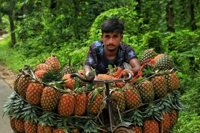 Portrait of man holding pineapple