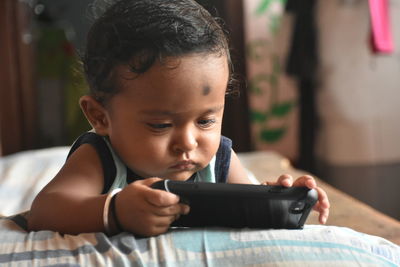 Close-up of boy using mobile phone