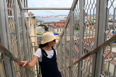 Woman standing amidst railing