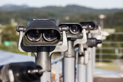 Coin operated binoculars against blurred landscape