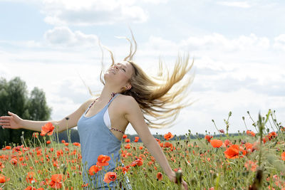 Woman with flowers in field