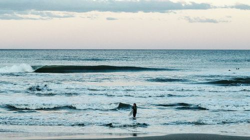 Rear view of man walking on beach