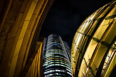 Low angle view of modern building against sky at night