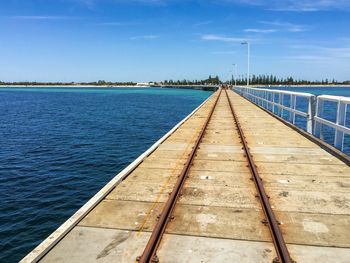 Railroad tracks on busselton jetty against sky