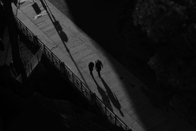 High angle view of silhouette people walking on street