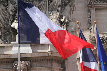 Low angle view of flags against historical building