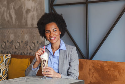 Businesswoman with cold coffee sitting in cafe