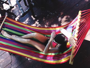 High angle view of woman relaxing on hammock