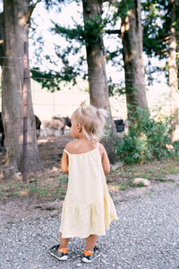 Full length of girl standing by tree