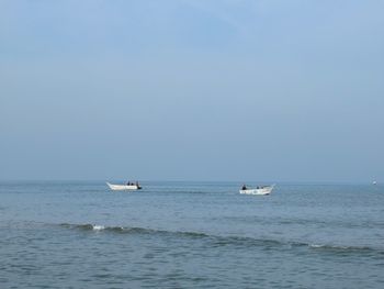 Sailboat in sea against clear sky