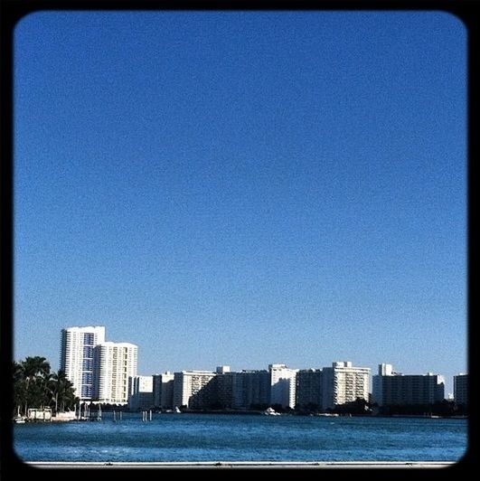 clear sky, building exterior, copy space, architecture, built structure, blue, water, waterfront, city, sea, transfer print, cityscape, auto post production filter, skyscraper, skyline, urban skyline, river, day, outdoors, tower