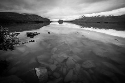 Scenic view of lake against sky during winter