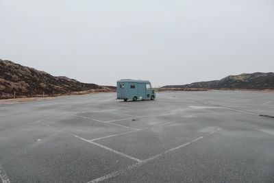Van at parking lot against sky