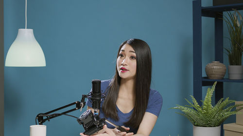 Beautiful woman podcasting in studio