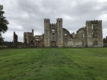 Historic building on field against sky