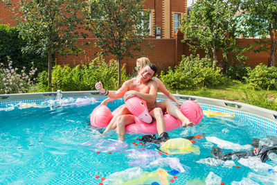 Woman sitting in swimming pool