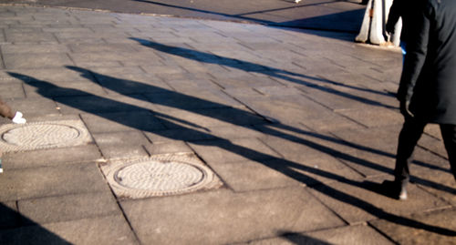 Low section of man shadow on floor