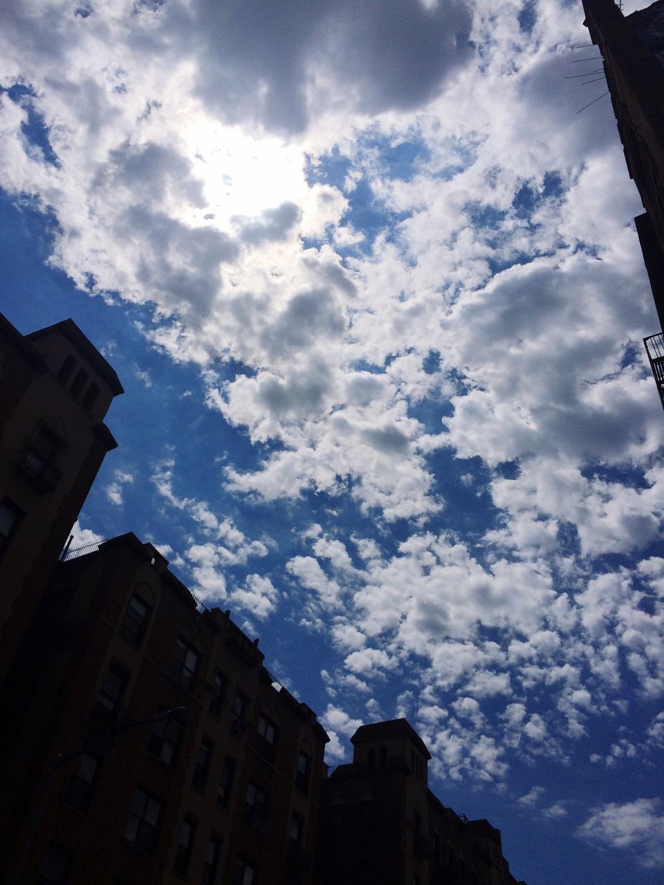 architecture, built structure, building exterior, low angle view, sky, cloud, cloud - sky, city, cloudy, high section, day, outdoors, blue, cloudscape, scenics, no people, outline, majestic, city life, cumulus cloud