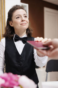 Portrait of young woman holding food at home