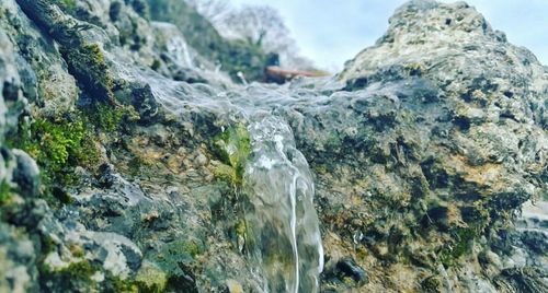 Close-up of waterfall against sky