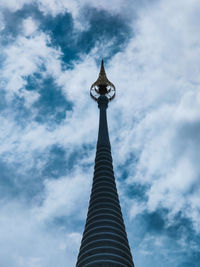 Low angle view of statue of building against cloudy sky