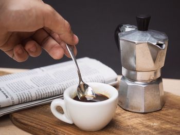 Midsection of coffee cup on table