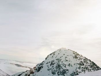 Scenic view of snow covered mountains against sky