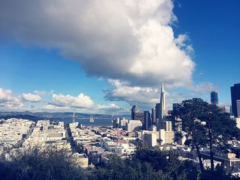 View of cityscape against cloudy sky