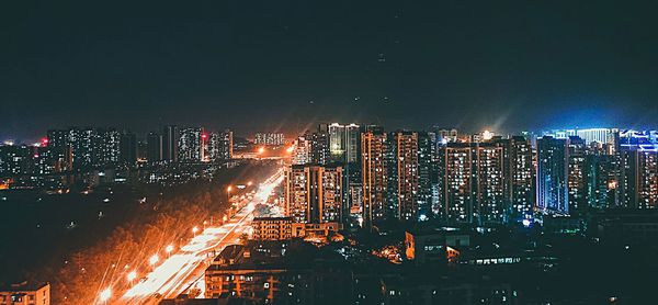 High angle view of illuminated city buildings at night