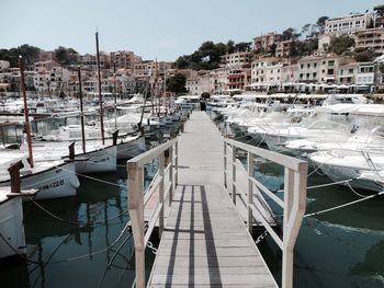 Pier amidst moored boats at river