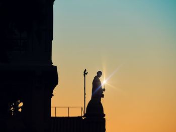 Low angle view of silhouette statue against clear sky