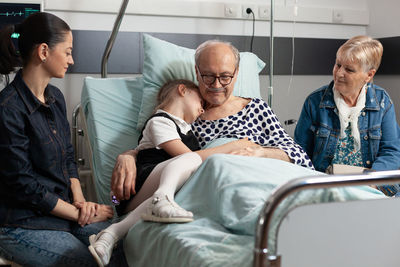 Grandfather with granddaughter at hospital